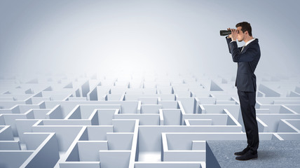 Wall Mural - businessman standing on maze and looking forward to the future concept