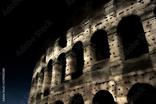 Fotografie, Obraz A section of the facade of the Colosseum (Flavian Amphitheatre) in Rome during the blue hour
