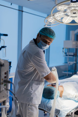 Canvas Print - Medical team preparing equipment for surgery in operation room.