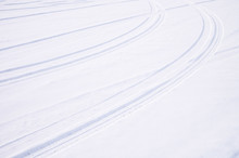 Traces Of Intersecting Arcs Of Automobile Tires In Fresh Snow