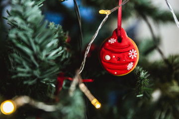 Wall Mural - Hand painted Christmas gingerbread ball on Christmas tree. Close-up.