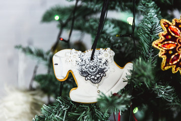 Wall Mural - Hand painted Christmas gingerbread horse on Christmas tree. Close-up.