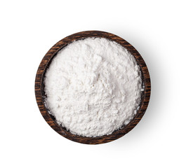 Pile of flour in wood bowl isolated on white background .top view