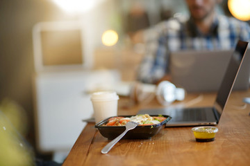 Close up of salad and coffee in co working space