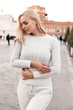 beautiful sexy woman with blond hair in cozy casual suit posing in antic Rome