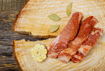 Wall Mural - Marinating meat with spices on wooden table