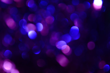 Bokeh. Holiday background. Christmas lights. Glitter. Defocused sparkles. New Year backdrop. Festive wallpaper. Blinks. Carnival. Tinsel. Bokeh retro style photo.