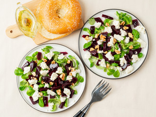 beetroot salad with feta, cheese, walnuts, corn salad and Brined cheese, pickled on white table, top view