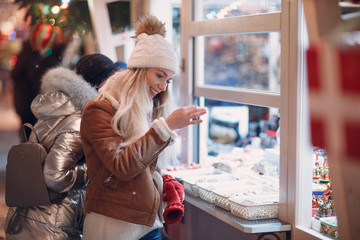 Wall Mural - Young woman shopping at New Year Fair