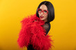 © Mat Hayward - Pretty Asian woman wearing vibrant red feather boa and heart shaped glasses