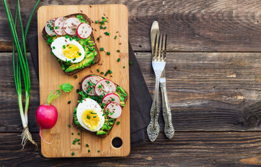 Wall Mural - Toasts with avocado, eggs, radish and green onion