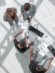 Wall Mural - High angle view of businessmen at table in office