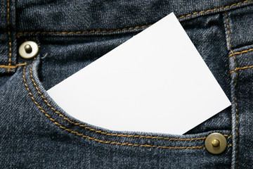 blank white paper or card in front pocket of dark blue jeans with copyspace for sale text or business concept