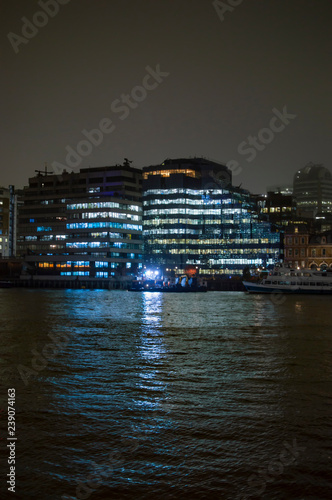 Fotografie, Obraz Offices on the bank of river thames and illuminated with lights having reflectio