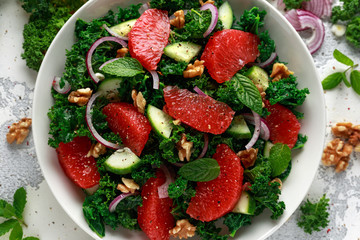Wall Mural - Healthy vegan food, vegetarian Grapefruit kale salad with walnuts, red onion and cucumber
