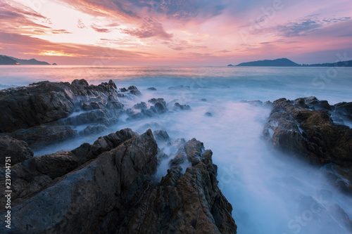 Fényképezés Long exposure image of Dramatic sky and wave seascape with rock in sunset scenery background