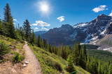 Amazing view of sunny touristic trail in the Rocky Mountains. The trail in mountains near Moraine lake in Canadian Rockies, Banff National Park, Canada.