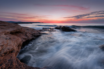 Wall Mural - Seascape during sunrise. Beautiful natural seascape. Sea sunrise at the Black Sea coast. Magnificent sunrise with clouds and fire sun at the beginning of April.Ravda, Bulgaria