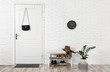 © New Africa - Hall interior with brick wall and white wooden door