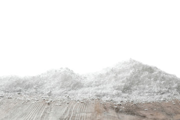 Wooden surface covered with snow against white background