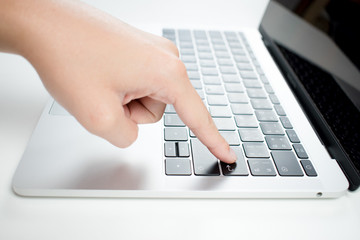 Close-up of a man's hand on a computer keyboard in the office.