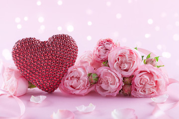 Beautiful rose flowers and heart on pink background. Greeting card or banner for Womens day or Valentines day.