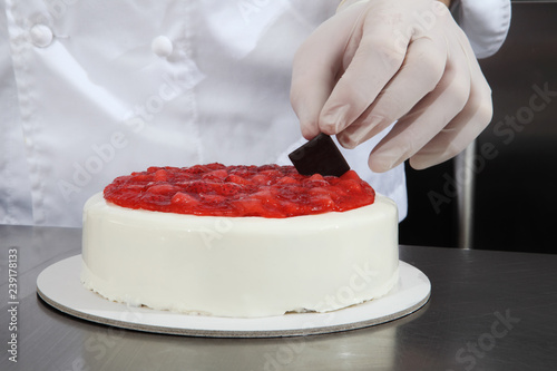 Hands Pastry Chef Prepares A Cake Cover With Icing And