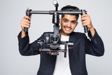 Asian Cameraman Holding Gimbal With Slr Camera Isolated On White Background