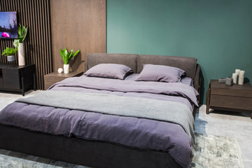 Wall Mural - Luxury studio apartment in a loft style in dark colors. Stylish modern cozy bedroom area