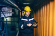 © Dusan Petkovic - Portrait of young Caucasian man dressed in work wear using tablet while standing in heating plant.