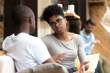 Focused African American Woman Talking With Man In Cafe, Girlfriend Discussing Relationships With Boyfriend, Explaining, Gesticulating, Friends Having Serious Conversation, Sitting Together On Couch