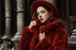 © Victoria Fox - Outdoor close up fashion portrait of young beautiful confident woman wearing trendy orange faux fur coat, hat, silvery hoop earrings, posing in street of european city. Copy, empty space for text