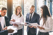 © sofiko14 - Six young business people analyze the results and discuss them. Group of business people collaborating on project in office