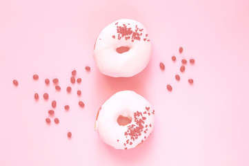 Wall Mural - White glazed donut  with black chocolate sweets on colar background. Flat lay. Food concept, colorful breakfast. Color of 2019. 