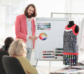 Wall Mural - fashion designer showing colleagues the color palette for the new collection