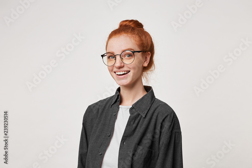 Cute Red Haired Girl Looks Into The Camera Through Glasses Gently