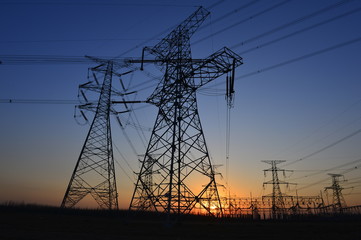 The silhouette of the evening electricity transmission pylon