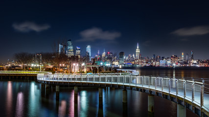 Fototapete - Pier C park in Hoboken, New Jersey by night, with the New York City skyline in the background.