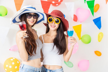 celebration new year or birthday party group of asian young woman and confetti happy,funny concept.drinking wine happy and fun in new year celebrate, color balloon  background.