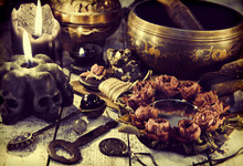 Still Life With Metal Singing Bowl, Black Candle With Skulls And Mirror With Dried Roses. Magic Ritual. Wicca, Esoteric And Occult Background With Vintage Witch Objects