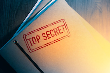private detective desk with envelopes labeled as top secret