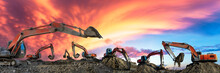 Many Excavators Work On Construction Site At Sunset,panoramic View