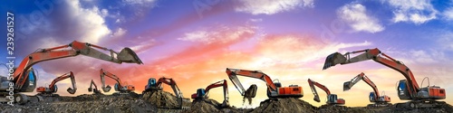 Cuadros en Lienzo Many excavators work on construction site at sunset,panoramic view