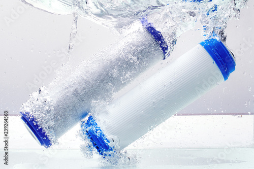 Fotografía New carbon filter cartridge for house water filtration system isolated on white background