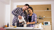© DC Studio - Happy young couple making cookies together.Kitchen fun.