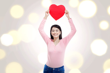 Wall Mural - Pretty asian woman with red heart on her hands