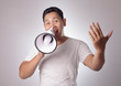 © airdone - Young Man With Megaphone Advertisement Concept, Smiling Expression