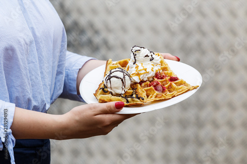 Fotografía Belgian waffles with a scoop of ice cream and with whipped cream and raspberries