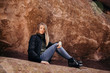 © MeganMahoneyPhotos - Young Cute Modern Caucasian Woman Smiling in Front of Massive Natural Red Rock Stone Wall Outside in Nature at the State Park
