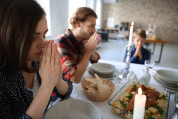 Wall Mural - Family praying before meal at home